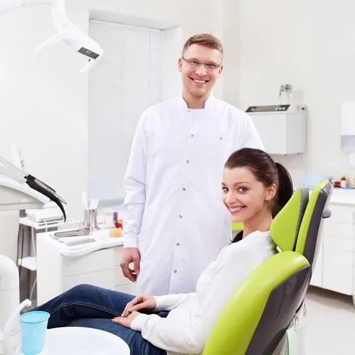 Dentist and patient in a bright treatment room