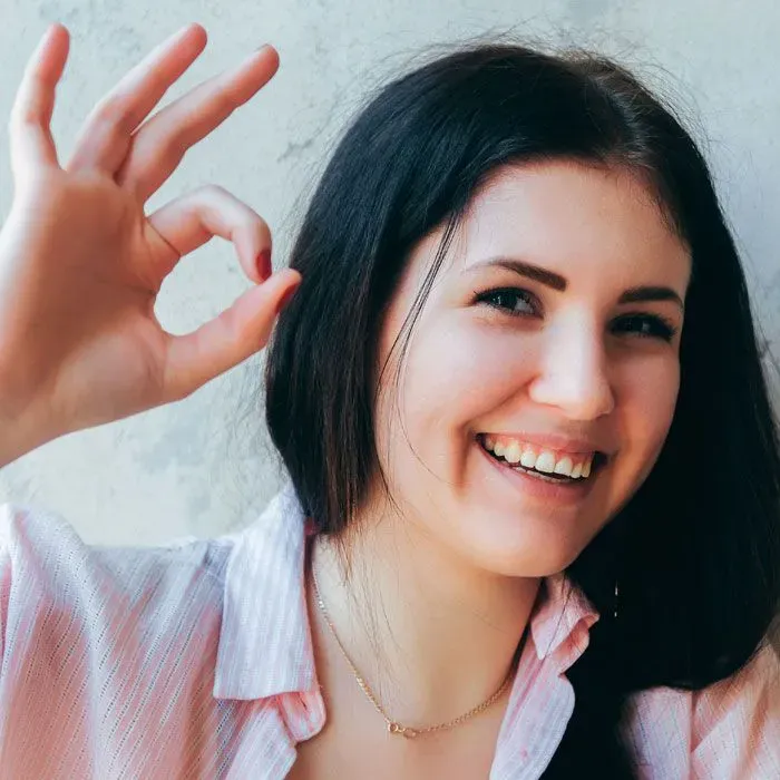 Patient giving an okay sign and smiling